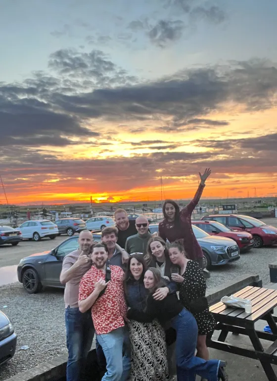 Our team in front of a sunset