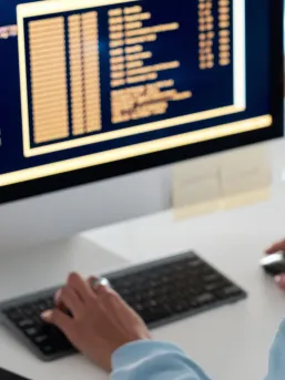computer screen and hands at a keyboard