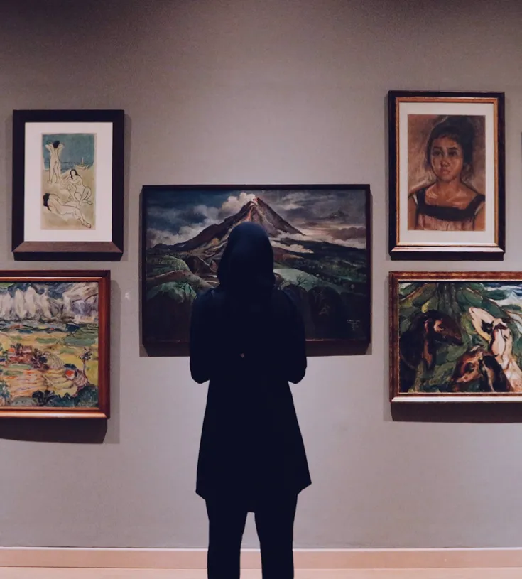 Person inside a museum looking at art